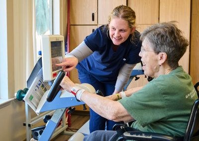 A nurse helping an elderly woman